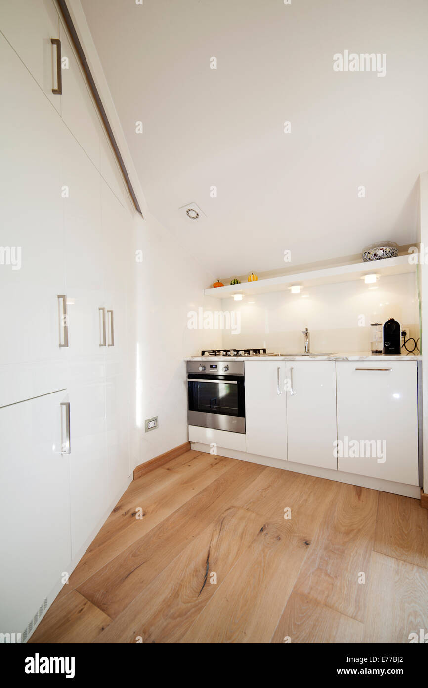 Small white modern kitchen in tiny city apartment Stock Photo