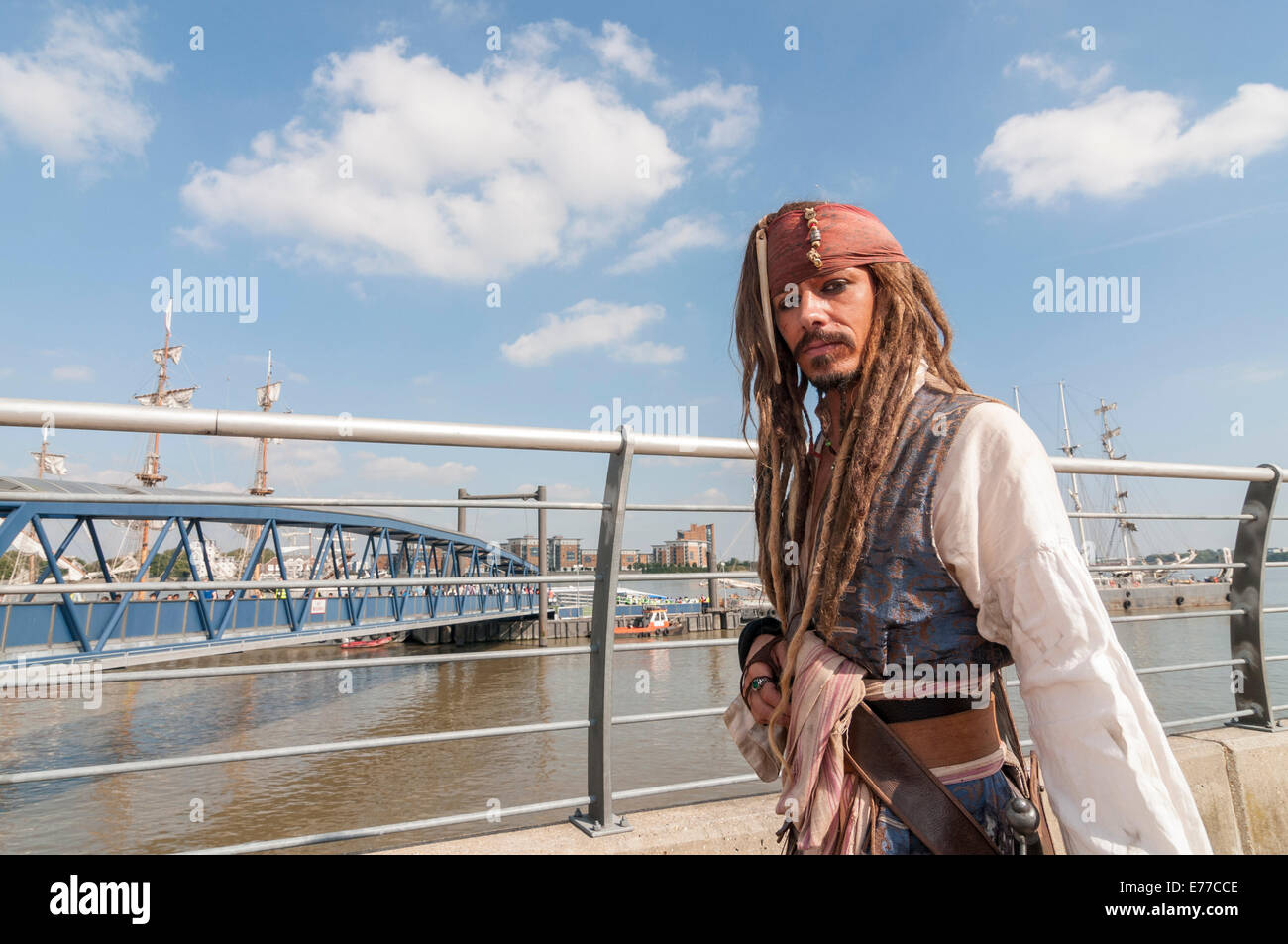 Woolwich, London, UK, 8 September 2014. As part of the month long Totally Thames event, The Royal Greenwich Tall Ships Festival celebrates the largest fleet of tall ships to visit London in 25 years.  Pictured: a Johnny Depp lookalike dressed as Captain Jack Sparrow from the movie 'Pirates of the Caribbean', poses for visitors waiting to board the tall ships. Credit:  Stephen Chung/Alamy Live News Stock Photo