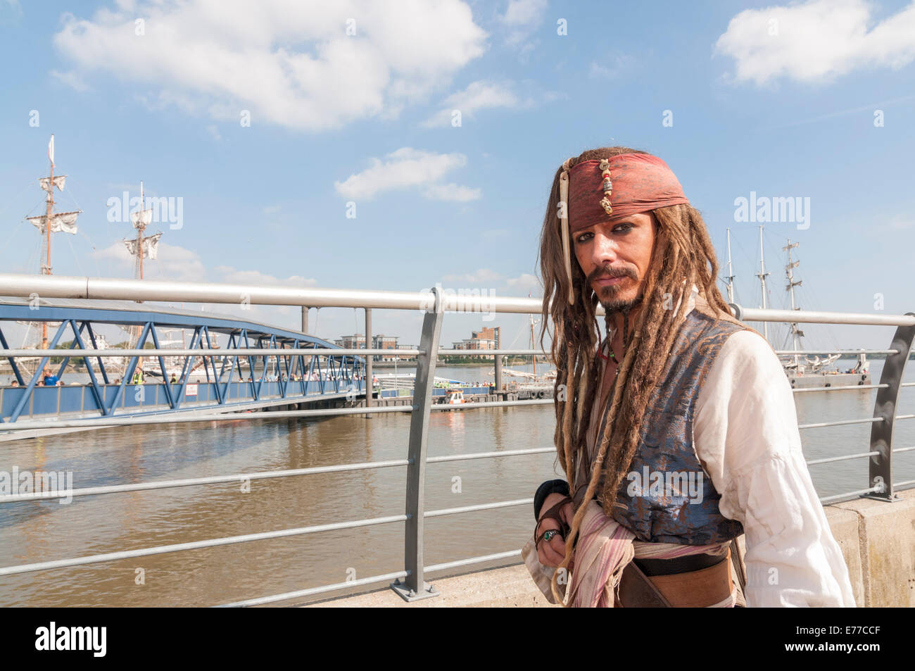 Woolwich, London, UK, 8 September 2014. As part of the month long Totally Thames event, The Royal Greenwich Tall Ships Festival celebrates the largest fleet of tall ships to visit London in 25 years.  Pictured: a Johnny Depp lookalike dressed as Captain Jack Sparrow from the movie 'Pirates of the Caribbean', poses for visitors waiting to board the tall ships. Credit:  Stephen Chung/Alamy Live News Stock Photo