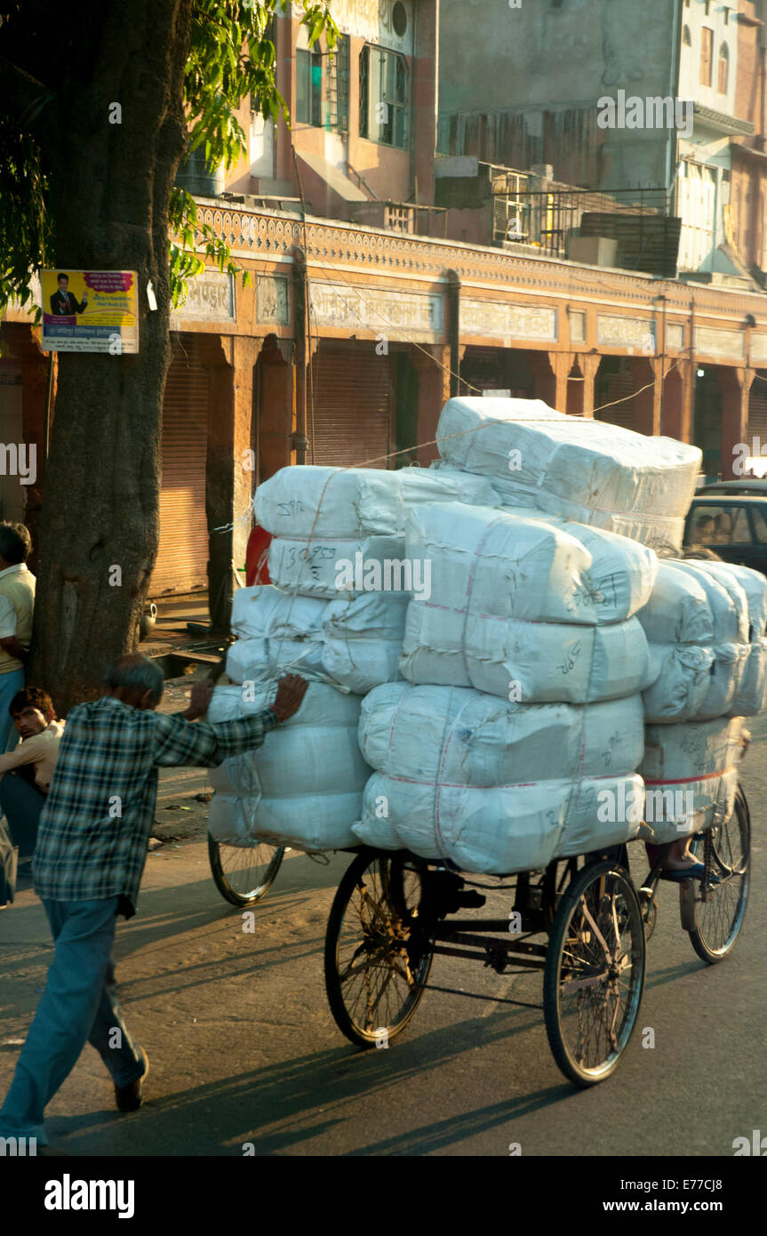 Man pushing an overloaded cart, Jaipur, Rajasthan, India. Stock Photo