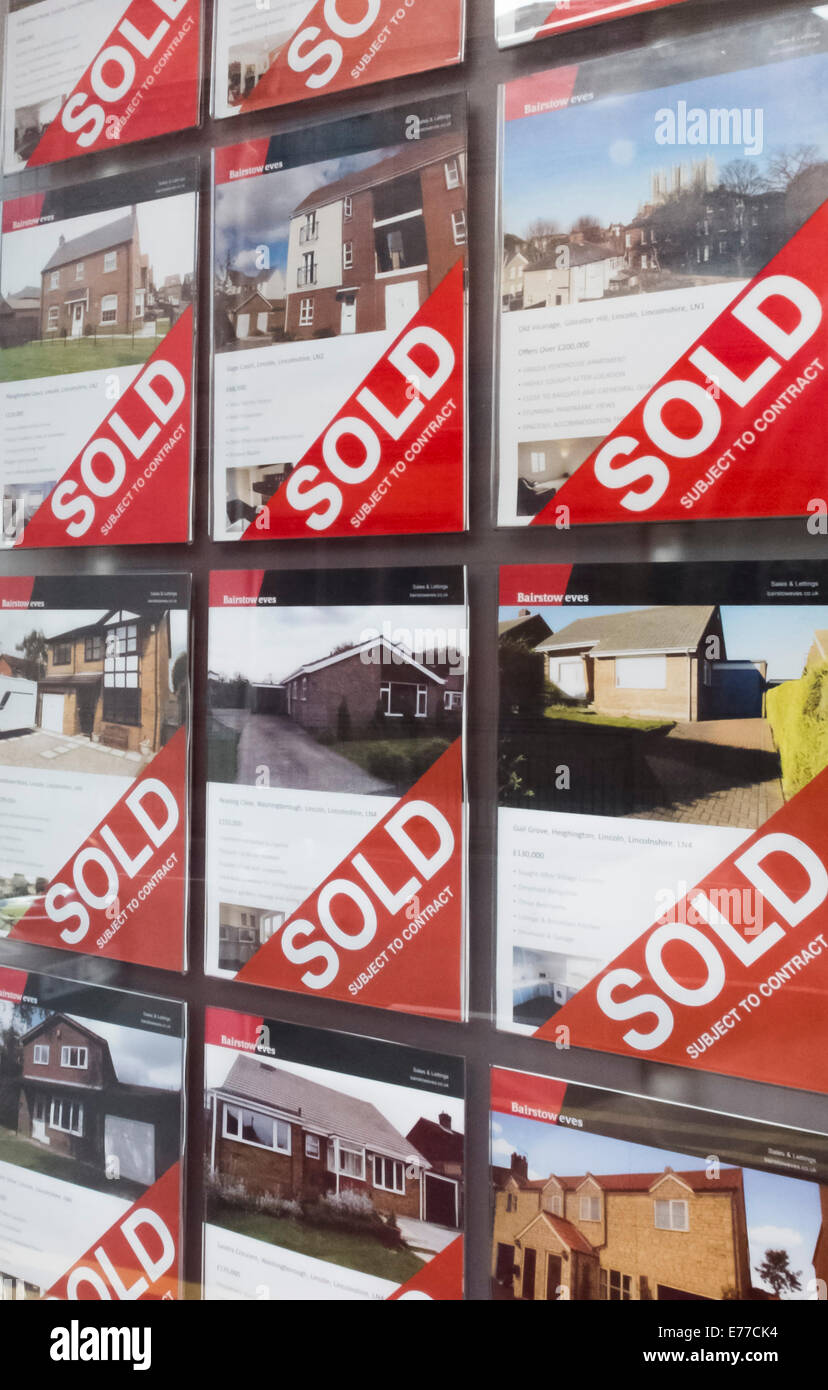 A full board of Sold house signs in the window of Bairstow Eves estate agents, Silver Street, Lincoln. Stock Photo
