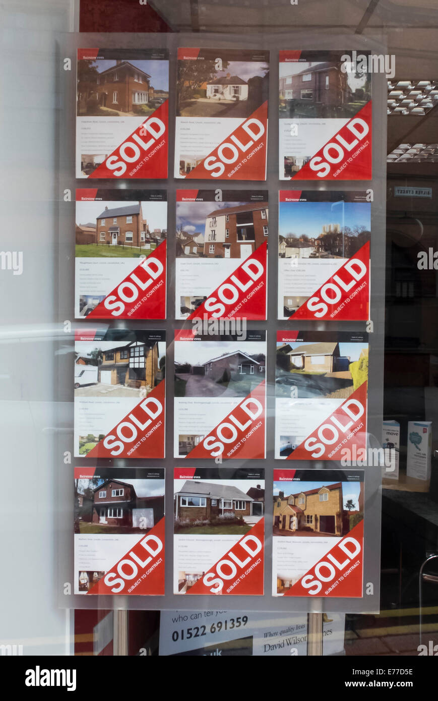 A full board of Sold house signs in the window of Bairstow Eves estate agents, Silver Street, Lincoln. Stock Photo