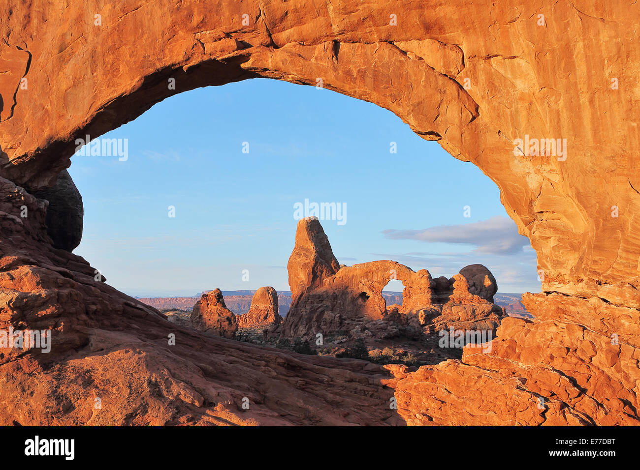 Turret Arch seen through the North Window Arch at sunrise in Arches