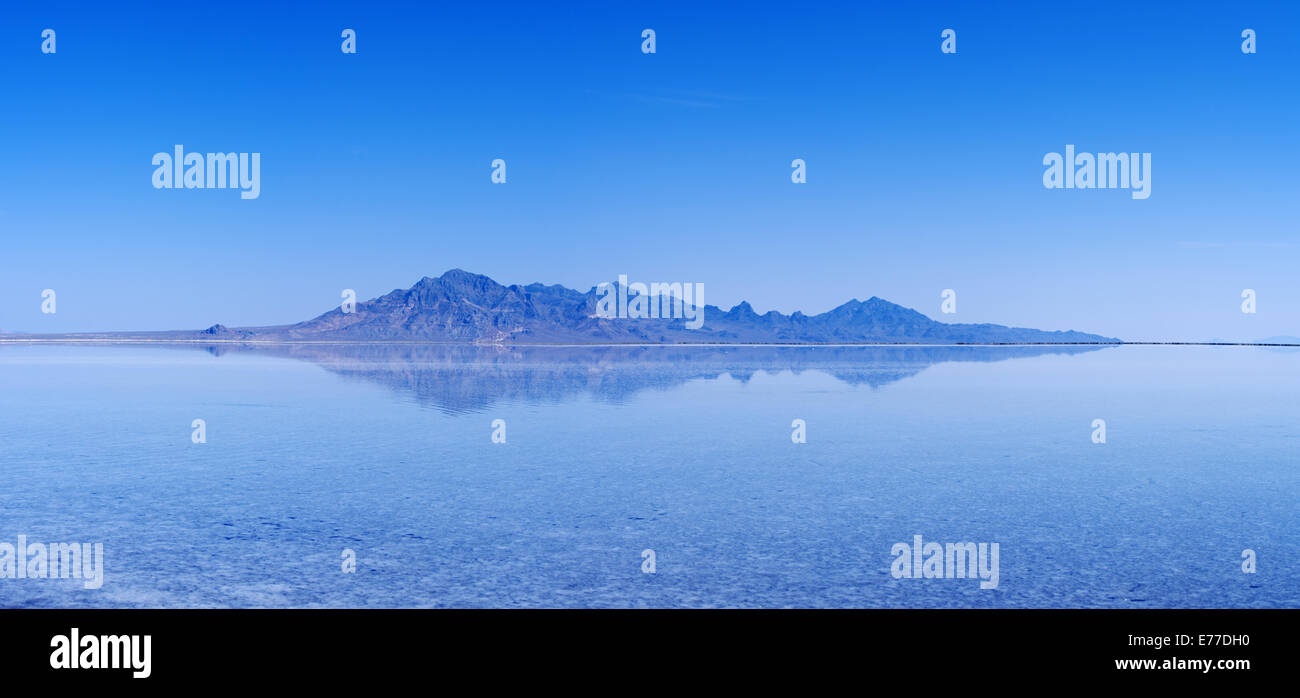 flooded Bonneville Salt Flats with distant mountains and blue sky reflection Stock Photo