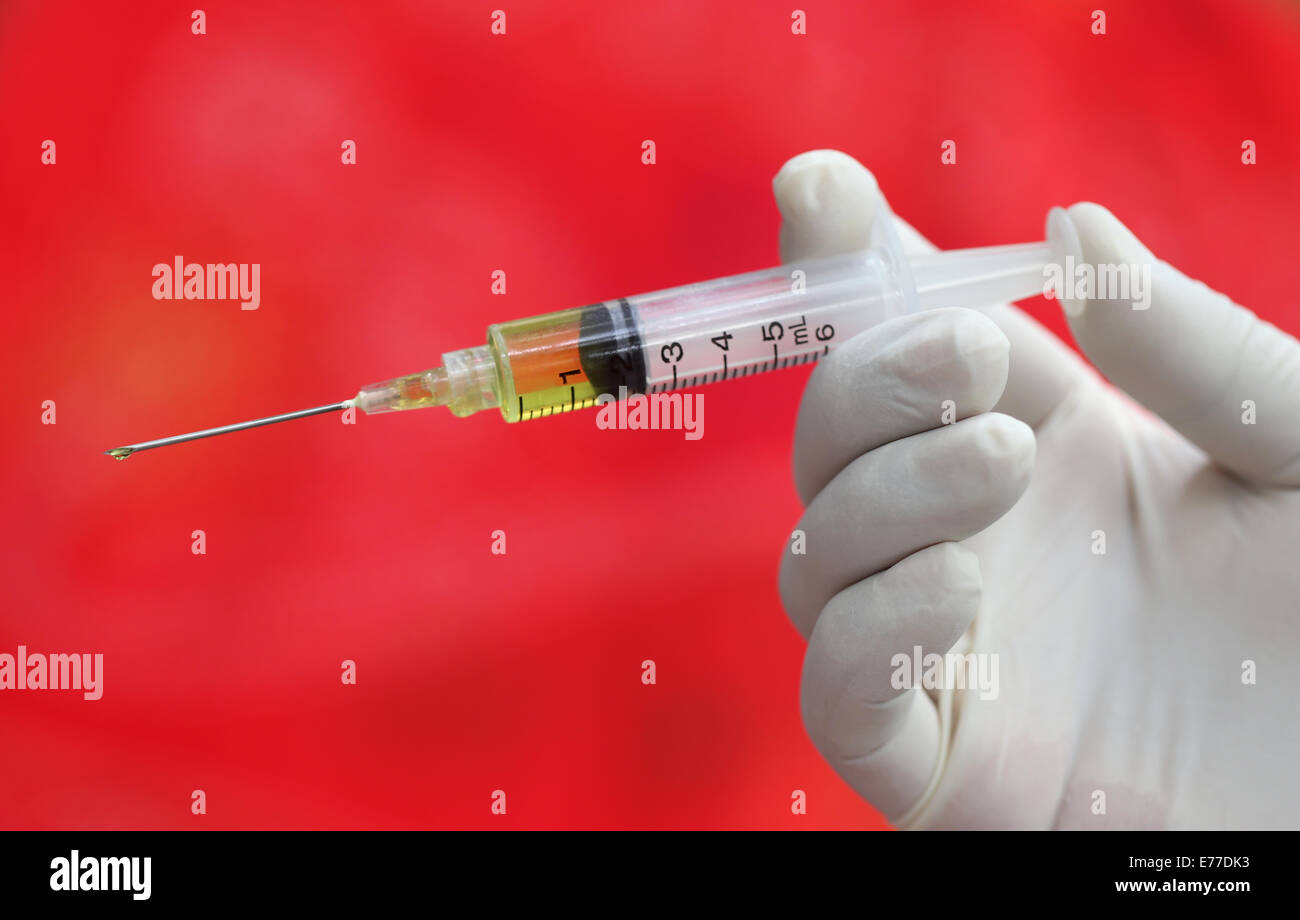 Close up of Hypodermic syringe holding by a hand Stock Photo Alamy