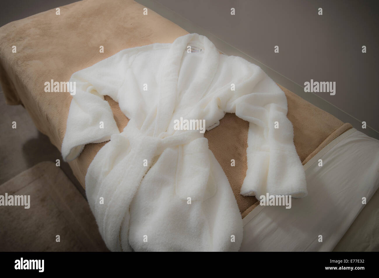 Soft Robe On Massage Table At Spa Stock Photo