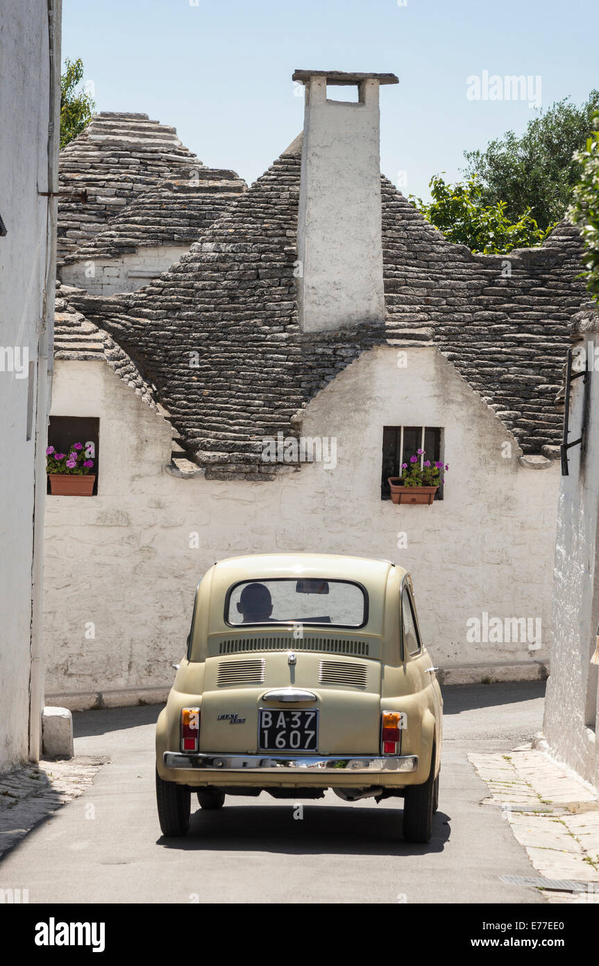 Fiat 500 and trulli houses at Alberobello, Puglia, Italy. Stock Photo
