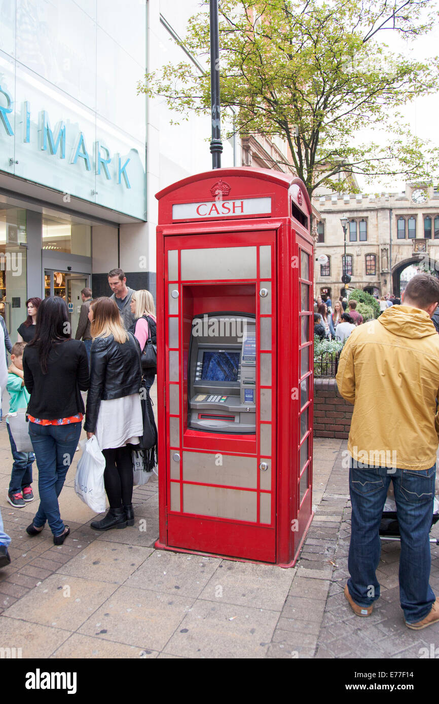 A traditional British telephone box converted into a cash machine Stock Photo