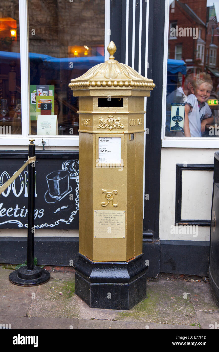 Postbox in Lincoln, England painted gold to celebrate Sophie Wells, gold medal winner in the London 2012 Olympic Games Stock Photo