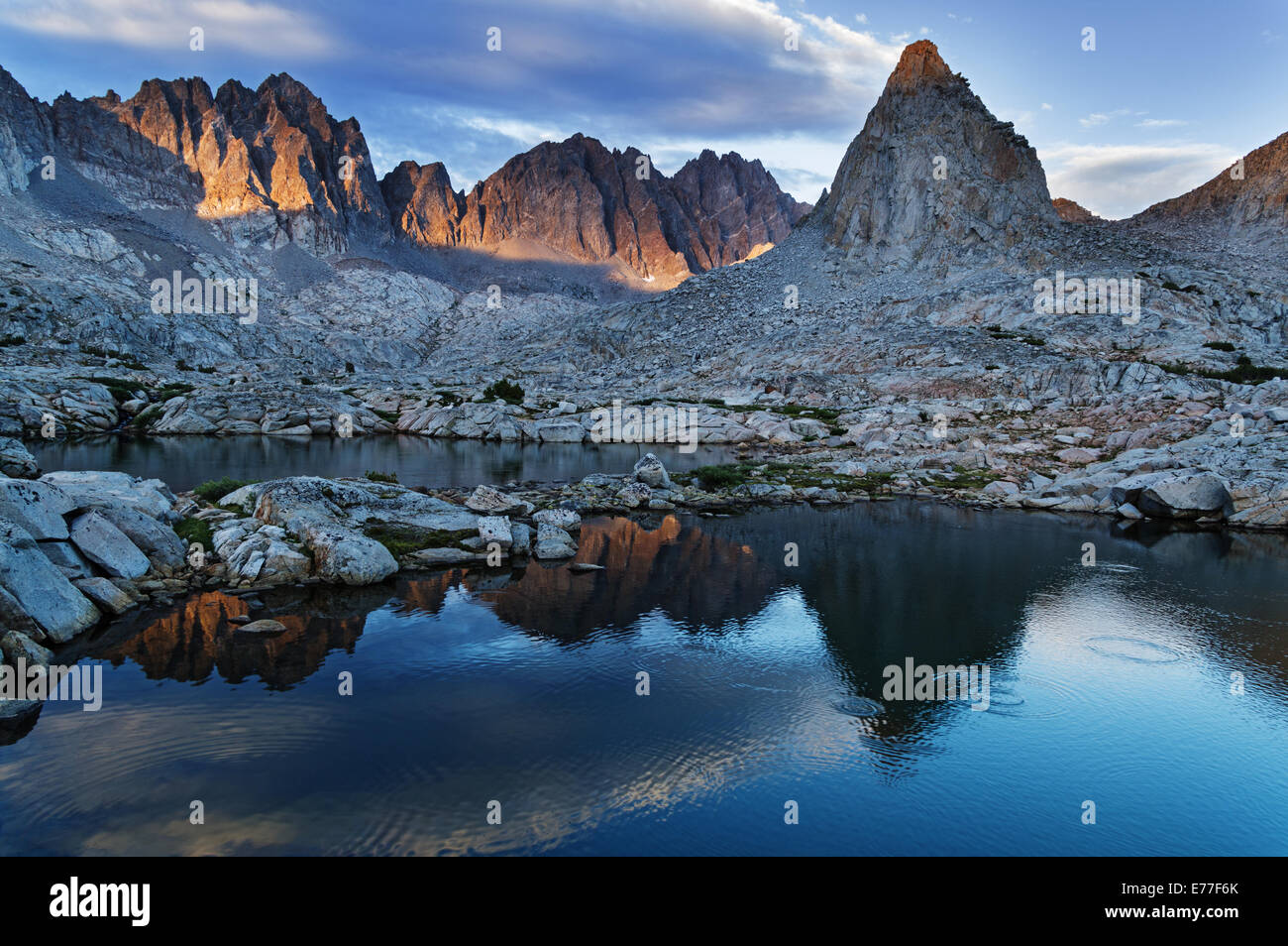 evening reflection of Isosceles and Mount Winchell and Thunderbolt in an alpine lake in Dusy Basin of the Sierra Nevada Mountain Stock Photo