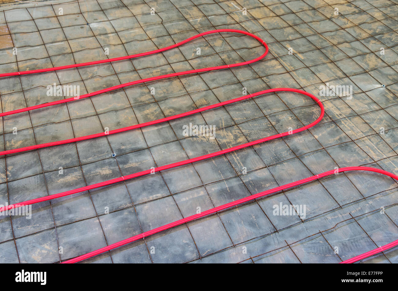 hydronic heat pex piping installation onto existing floor Stock Photo