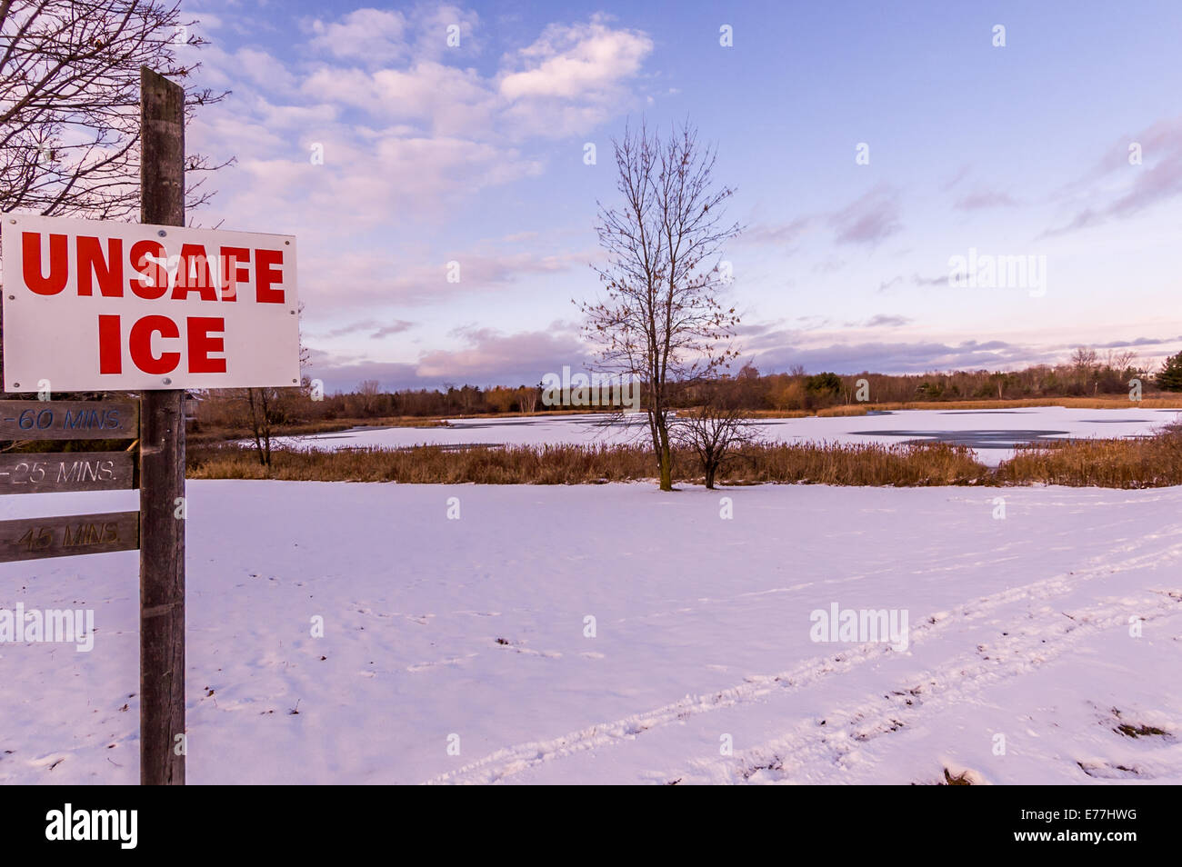 A sign warns of unsafe ice. Stock Photo