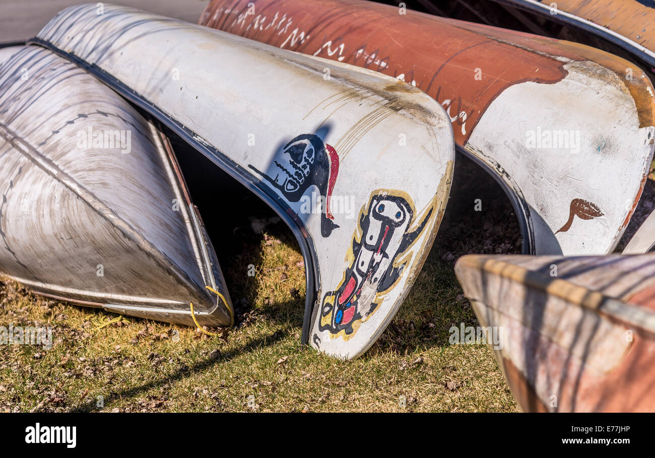 A close up of canoes up side down on grass. Stock Photo