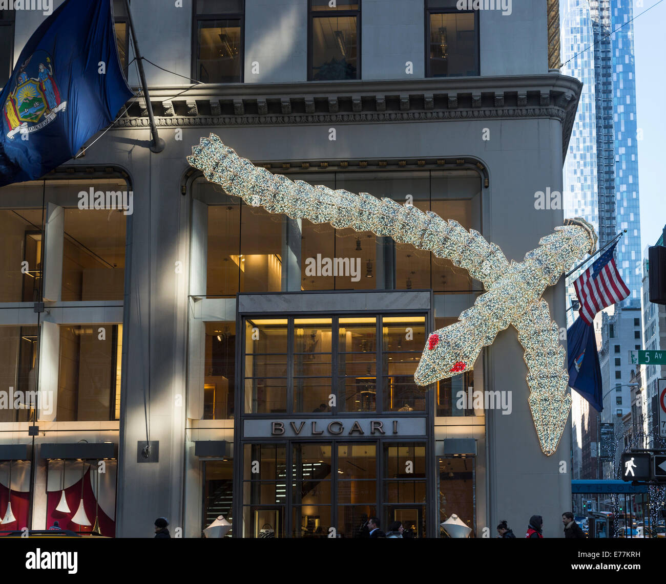 New York Bulgari illuminated serpent, seasonal Christmas decorations on the exterior of their upscale boutique store on 5th Avenue, downtown New York Stock Photo