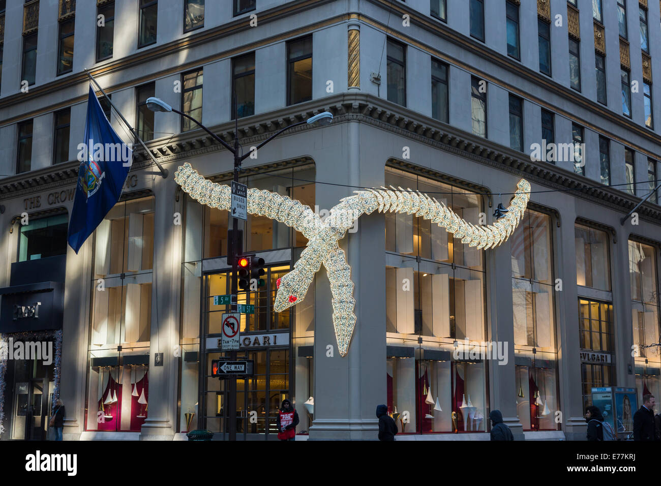 New York Bulgari illuminated serpent, seasonal Christmas decorations on the exterior of their upscale boutique store on 5th Avenue, downtown New York Stock Photo