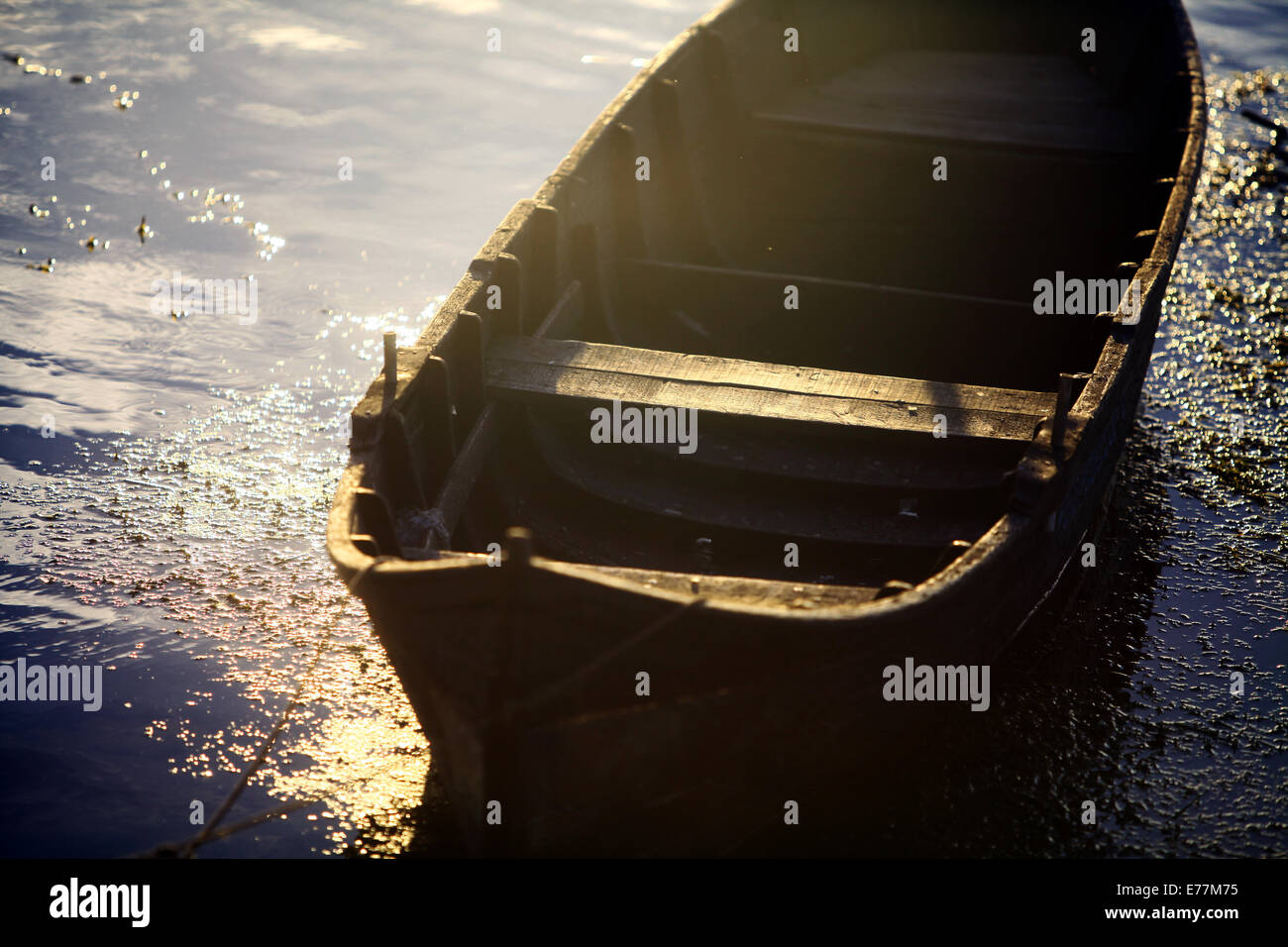 Color picture of a wooden boat on a river bank Stock Photo - Alamy