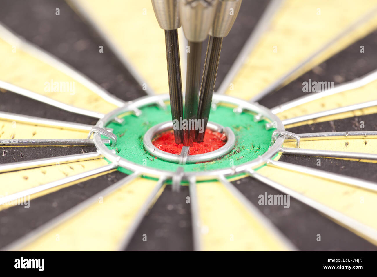 macro picture of the center of dartboard with three darts Stock Photo
