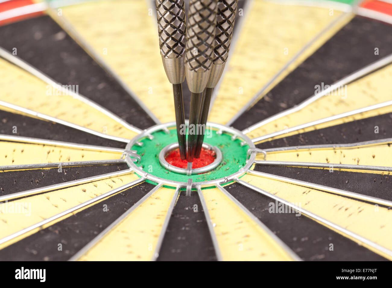 center of dartboard with three darts Stock Photo Alamy