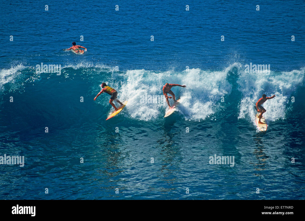 Three surfers riding same wave or dropping into wave in Southern California Stock Photo