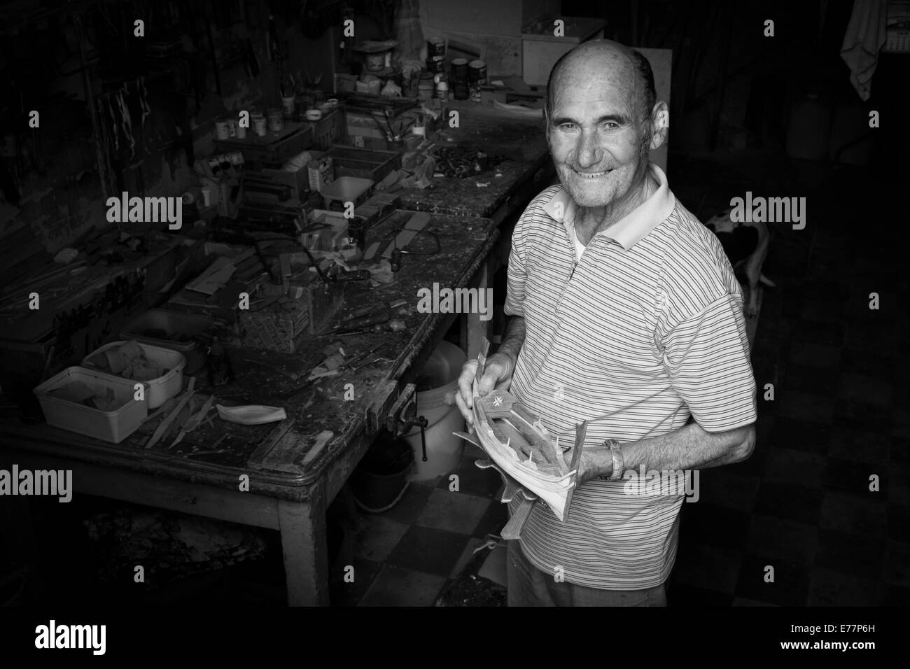 Man pictured at the entrance to his workshop where he makes model boats in Vittoriosa, Malta Stock Photo