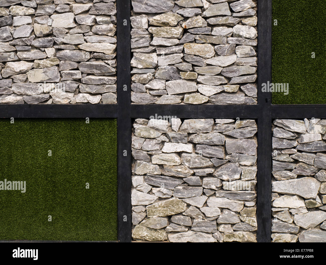 Artificial grass and stone wall as background Stock Photo - Alamy