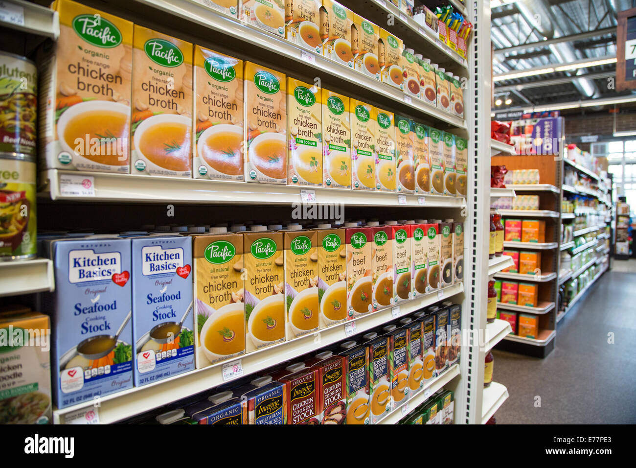 A natural foods grocery store aisle with organic broths and stocks. Stock Photo