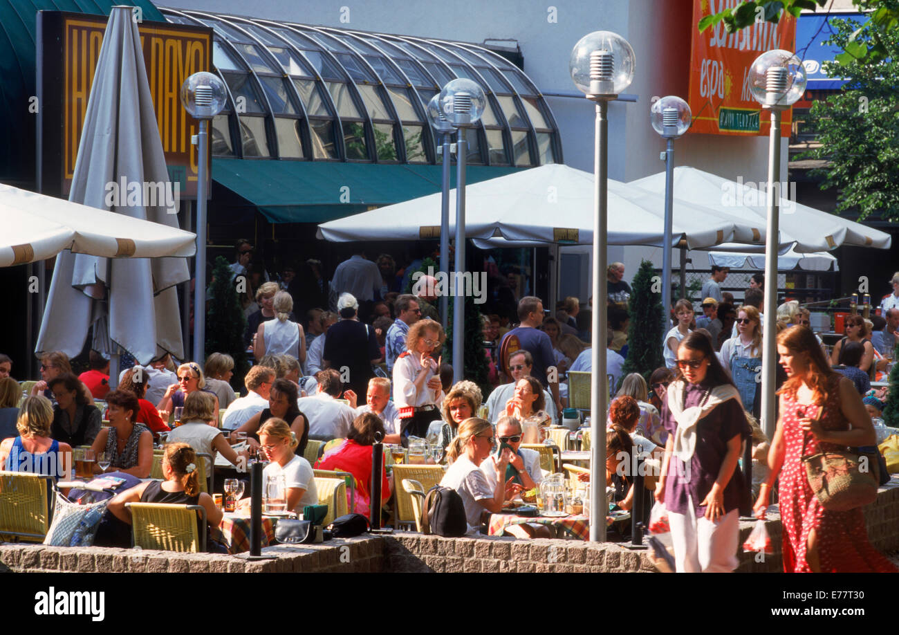 Summer tourists and activities around outdoor sidewalk restaurants in Helsinki, Finland Stock Photo