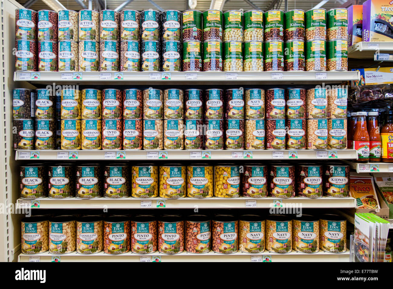 A natural foods grocery store aisle with cans of organic beans. Stock Photo