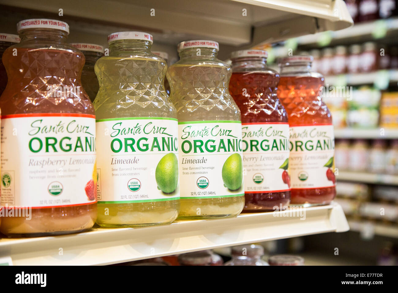 A natural foods grocery store aisle with a shelf of organic lemonade and limeade. Stock Photo