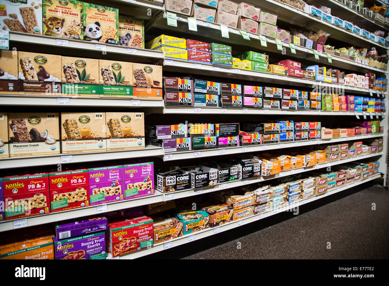 A natural foods grocery store aisle with shelves  of power protein bars. Stock Photo