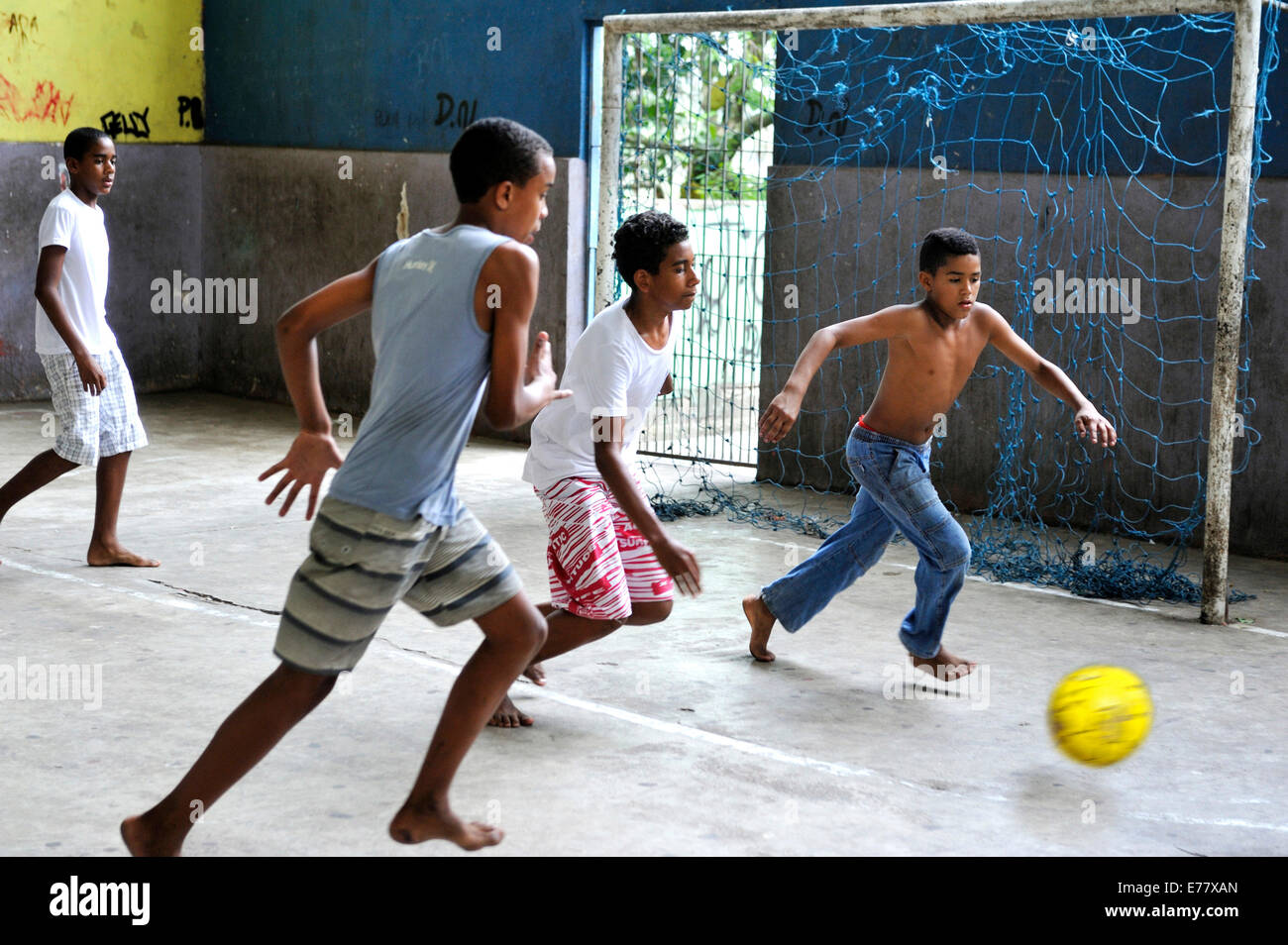 Teenagers playing soccer on a covered sports field, in the slums, Favela Cerro Corá, Rio de Janeiro, Brazil Stock Photo