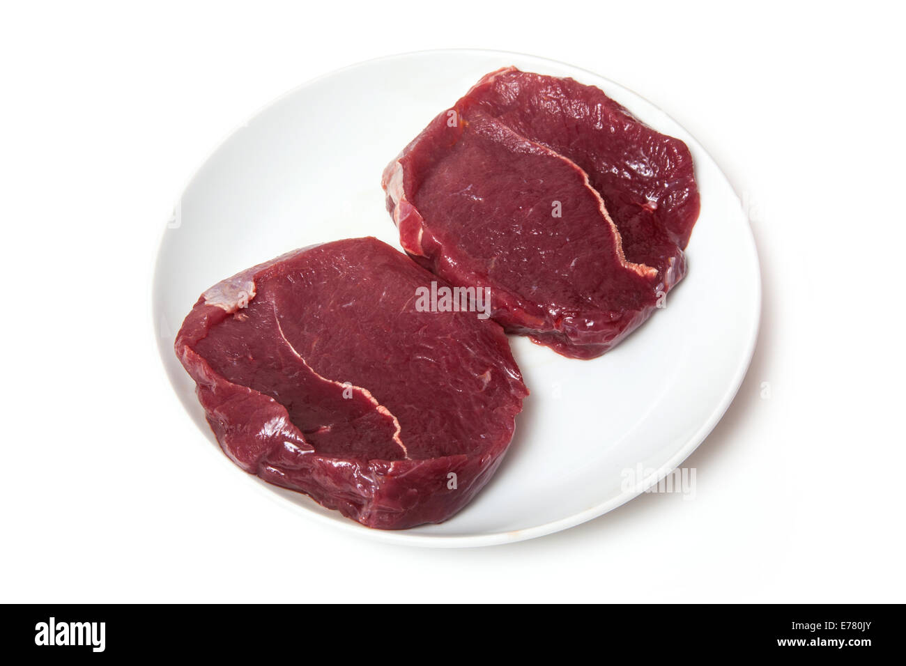 Plate of raw Zebra steaks isolated on a white studio background Stock