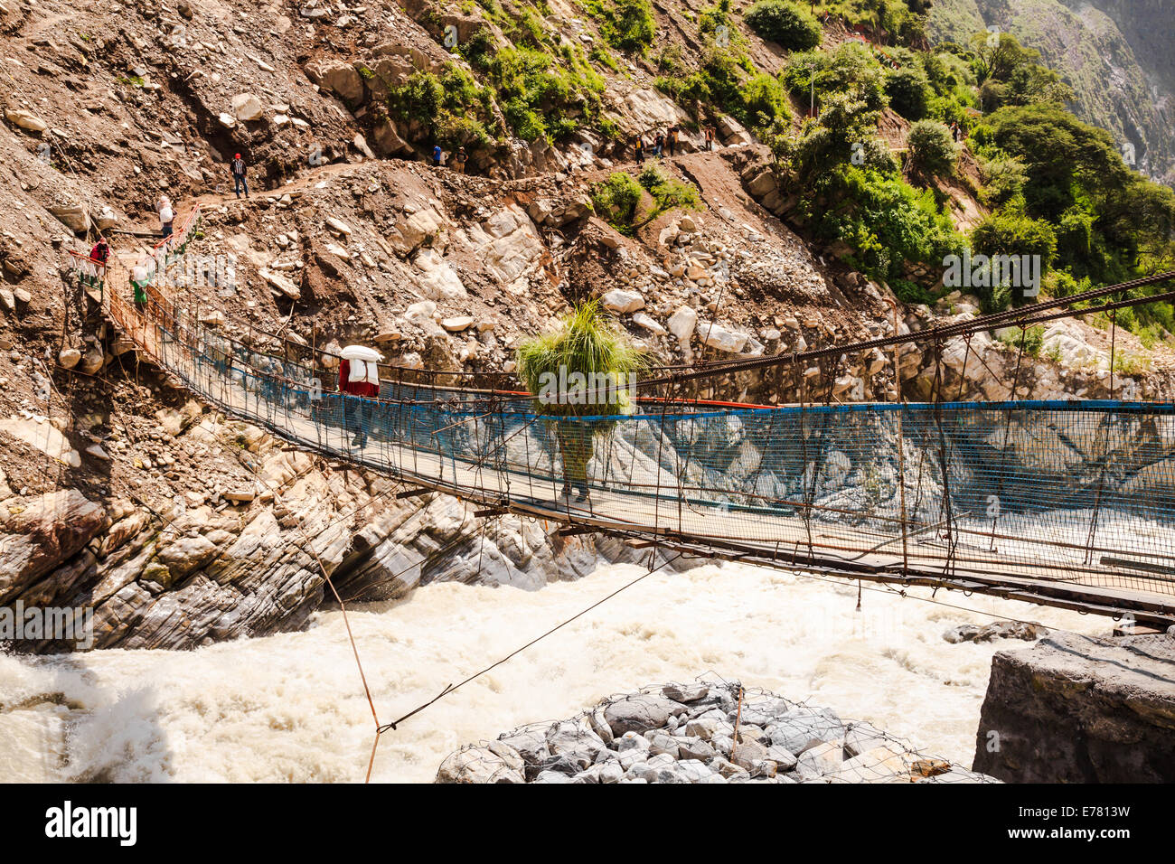 Crossing the suspension bridge in india Stock Photo Alamy