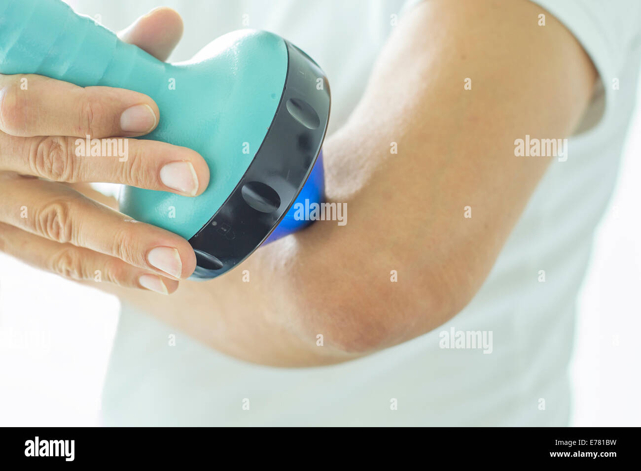 Shockwave therapy on the elbow Stock Photo