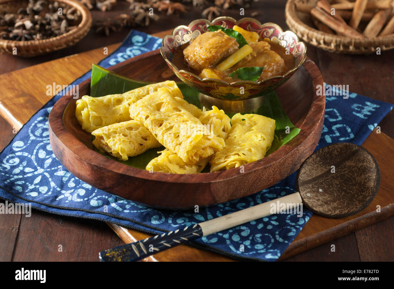 Roti jala with kari ayam. Lacy pancakes with chicken curry. Malaysia Food Stock Photo
