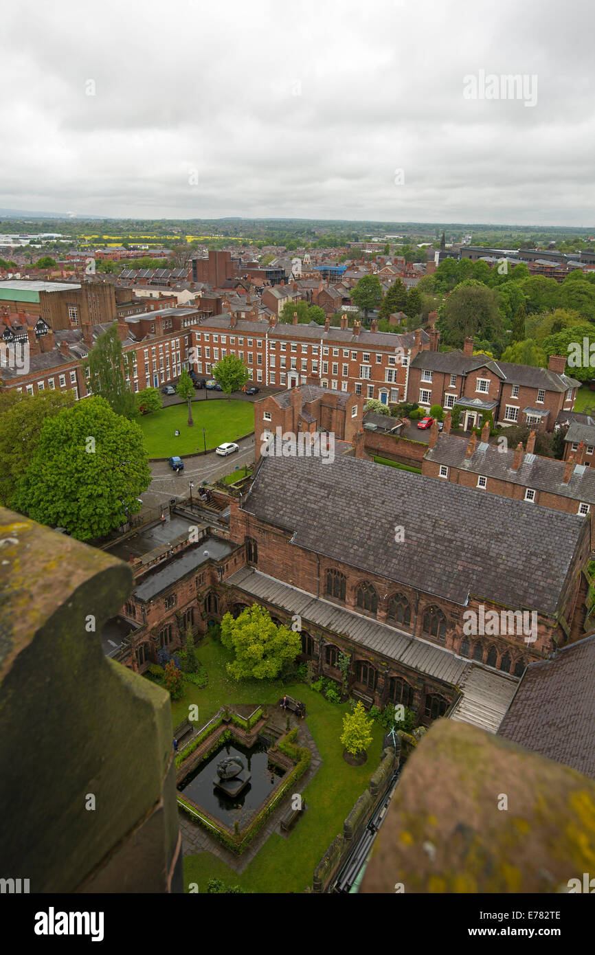 View of vast urban landscape, historic buildings, and gardens from high roof of cathedral in English city of Chester Stock Photo
