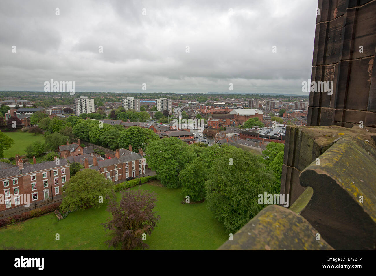 View of vast urban landscape dominated by high rise buildings from roof of historic cathedral in English city of Chester Stock Photo
