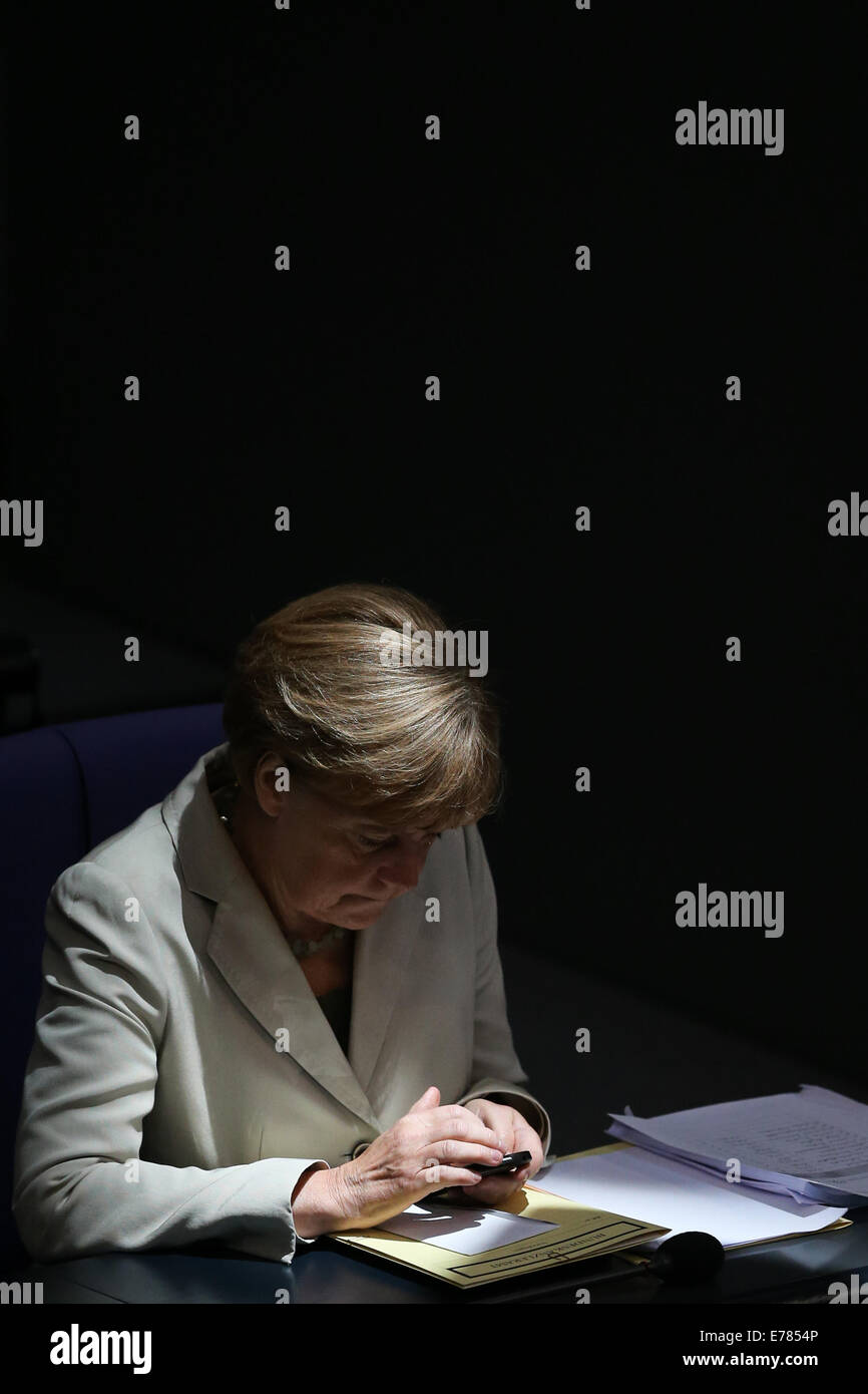 Berlin, Germany. 9th Sep, 2014. German Chancellor Angela Merkel checks her cellphone during a debate on the 2015 federal budget at the Bundestag, the lower house of parliament, in Berlin, Germany, on Sept. 9, 2014. Credit:  Zhang Fan/Xinhua/Alamy Live News Stock Photo