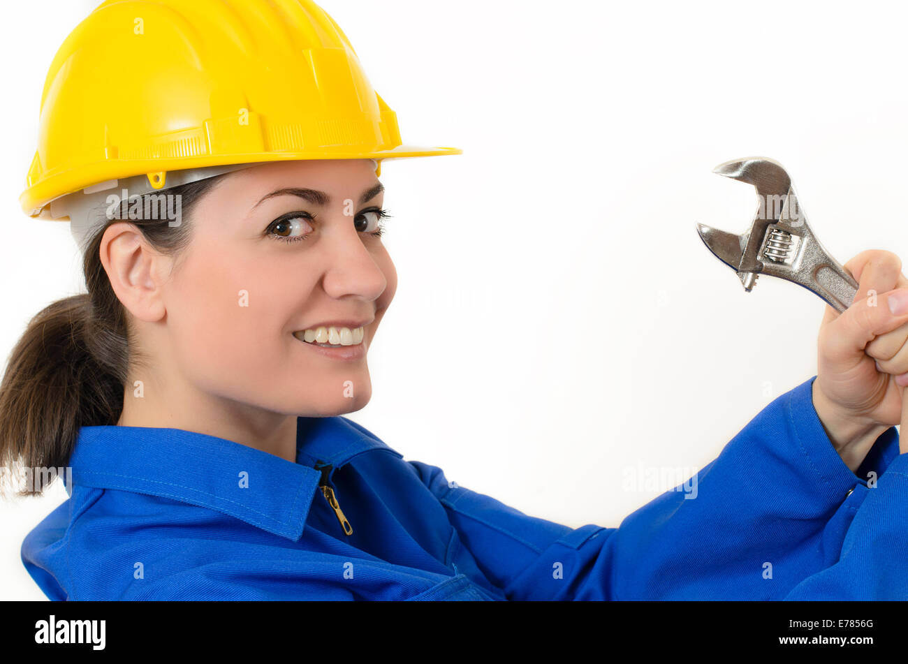 Woman wearing protective equipment holding adjustable wrench Stock