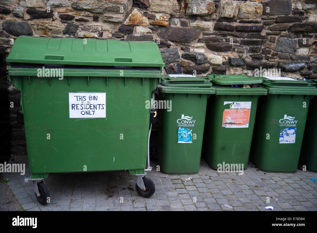 A row of refuse bins in Conwy, North Wales. With sign 'This bin for  residents only' Stock Photo - Alamy