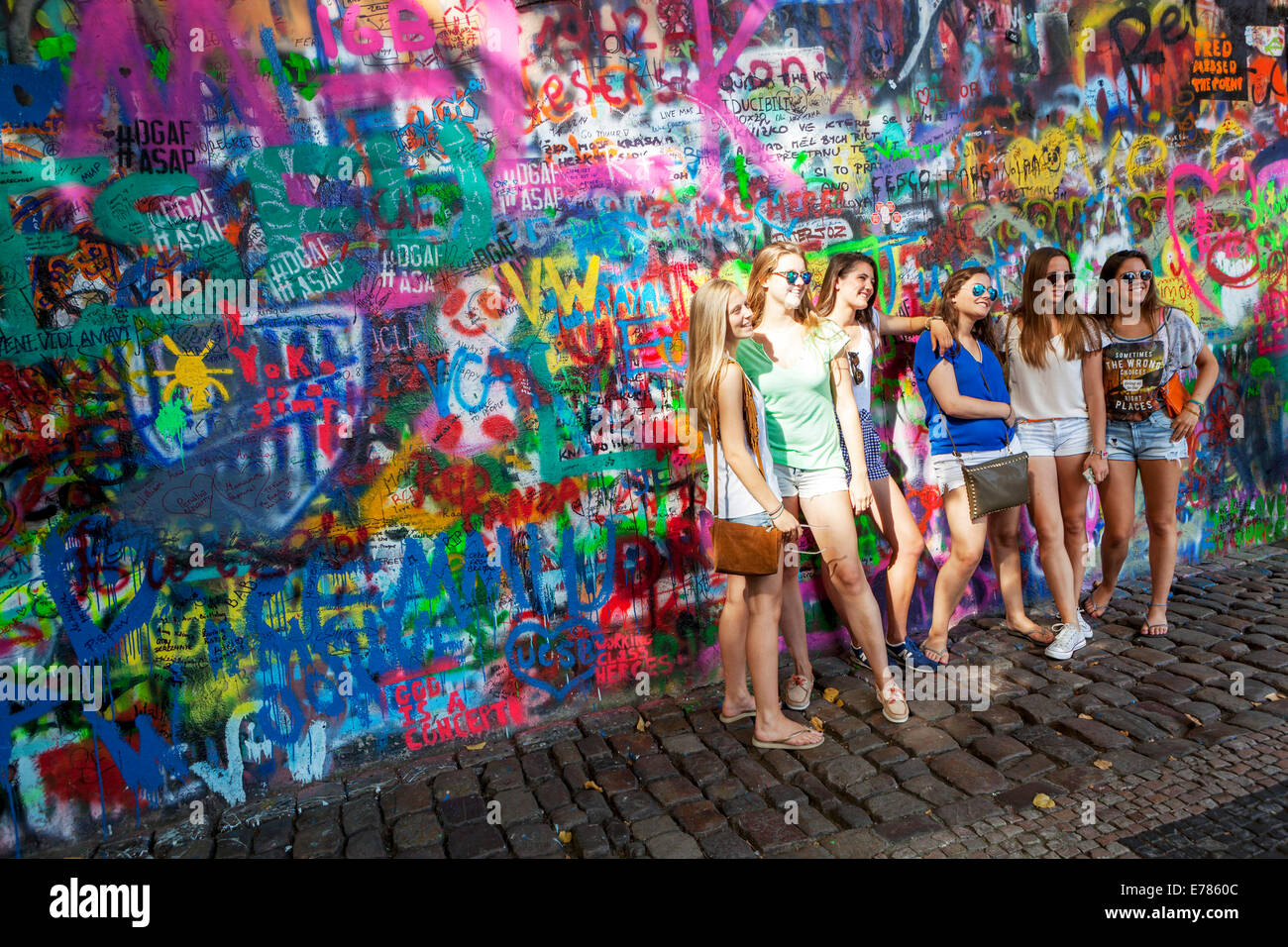 Group of pretty girls at the John Lennon Wall, Prague tourists Stock Photo