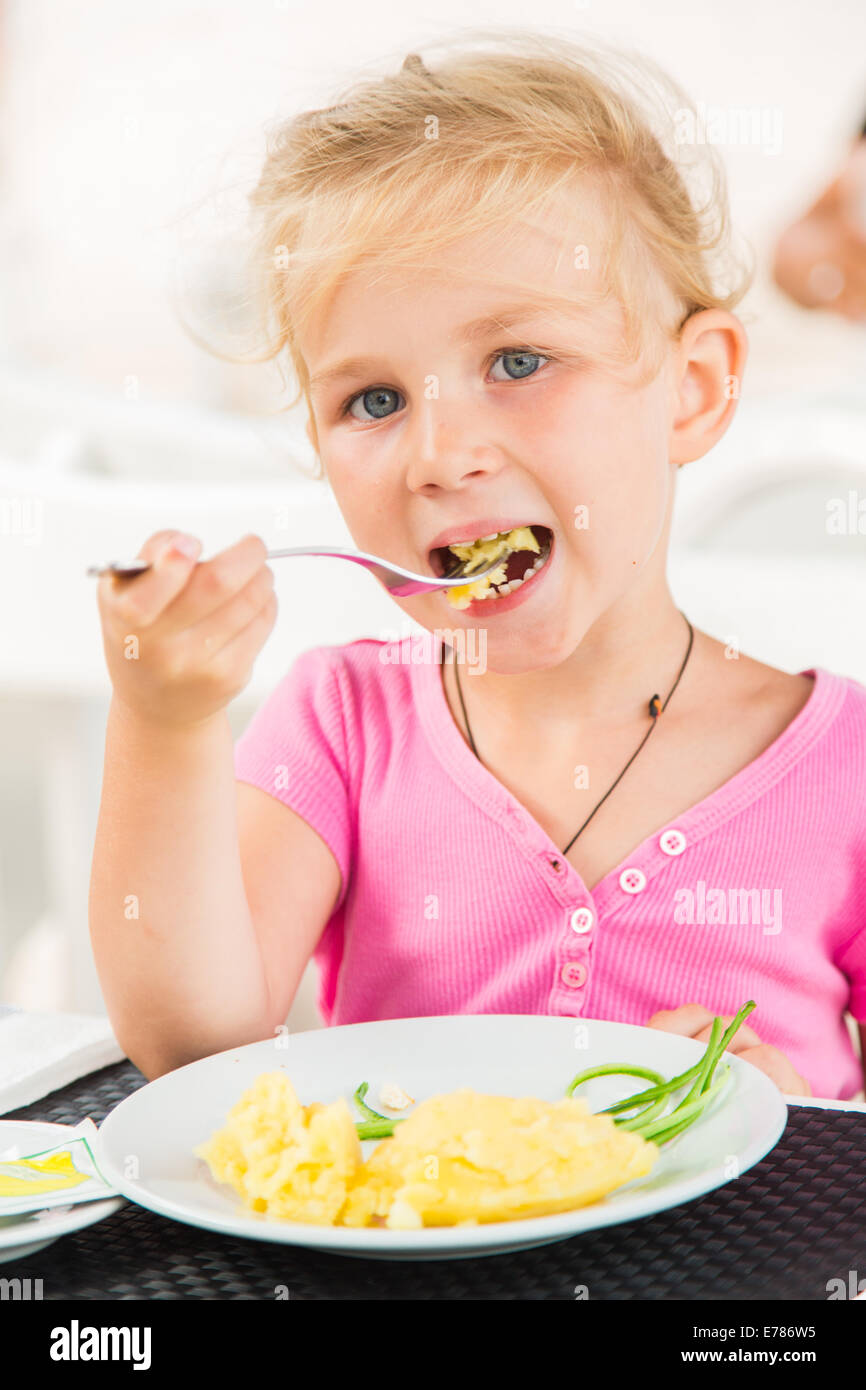 Cute girl eating lunch in outdoor cafe Stock Photo