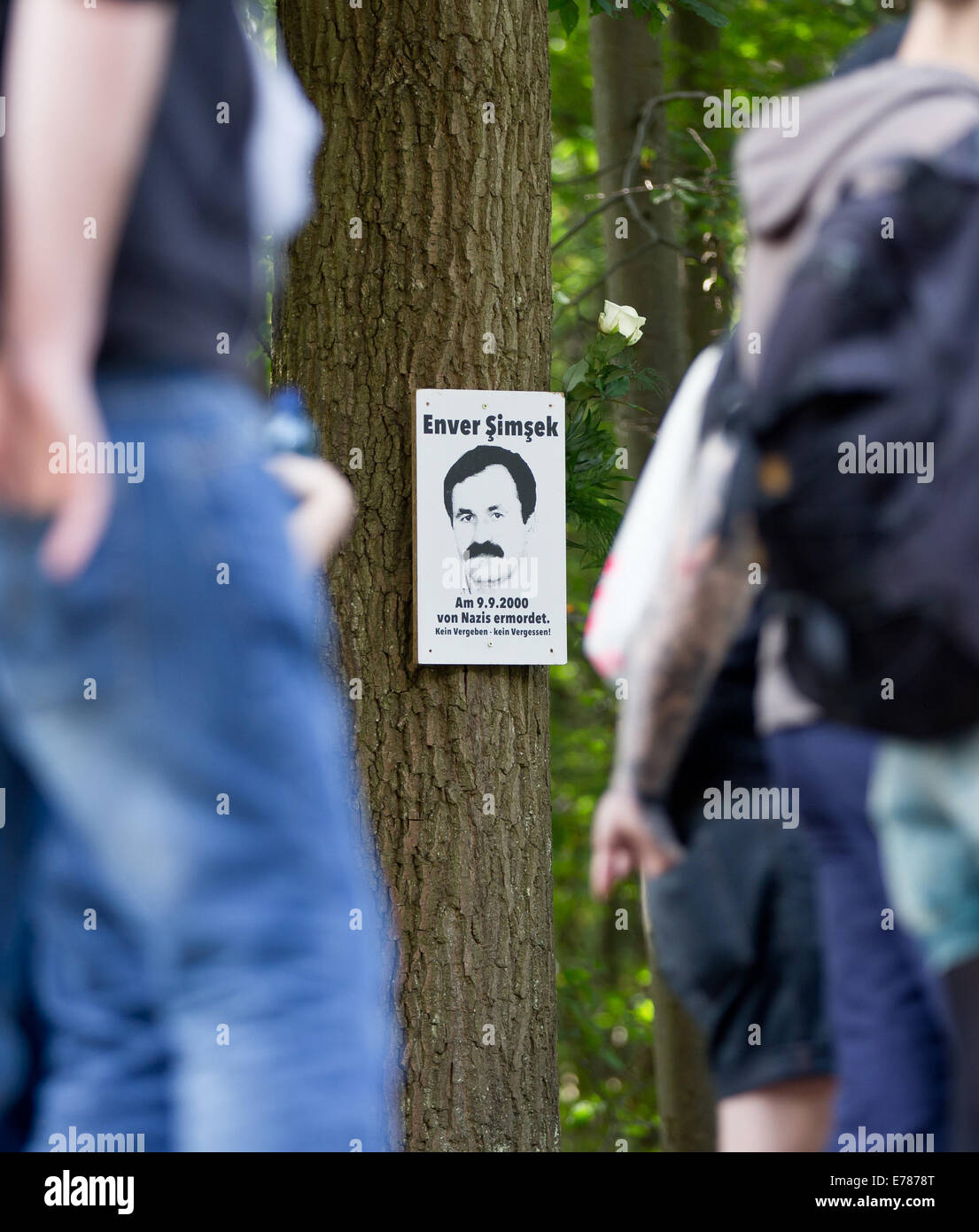 Participants in a rally in memory of Enver Simsek, who was murdered by the NSU, stand next to a picture of the murder victim at the site of the crime in Nuremberg, Germany, 09 September 2014. The Turkish florist Simsek was murdered by the NSU on 09 September 2000. Photo: DANIEL KARMANN/DPA Stock Photo