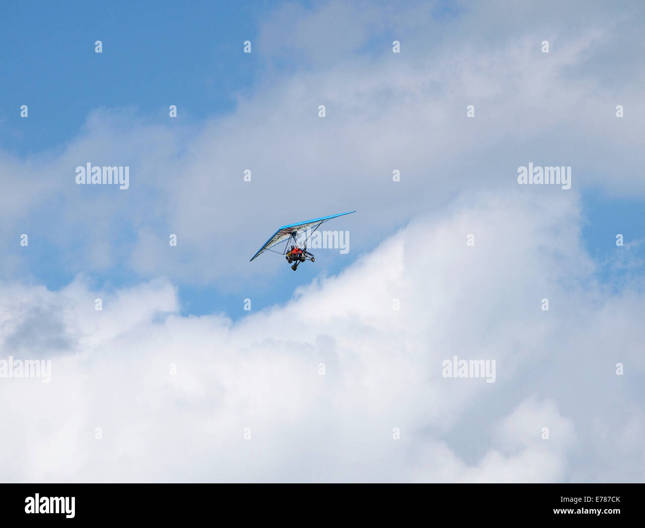Ultralight Aeroplane In Blue Sky With Clouds Jura France Stock Photo ultralight-aeroplane-in-blue-sky-with-clouds-jura-france-stock-photo