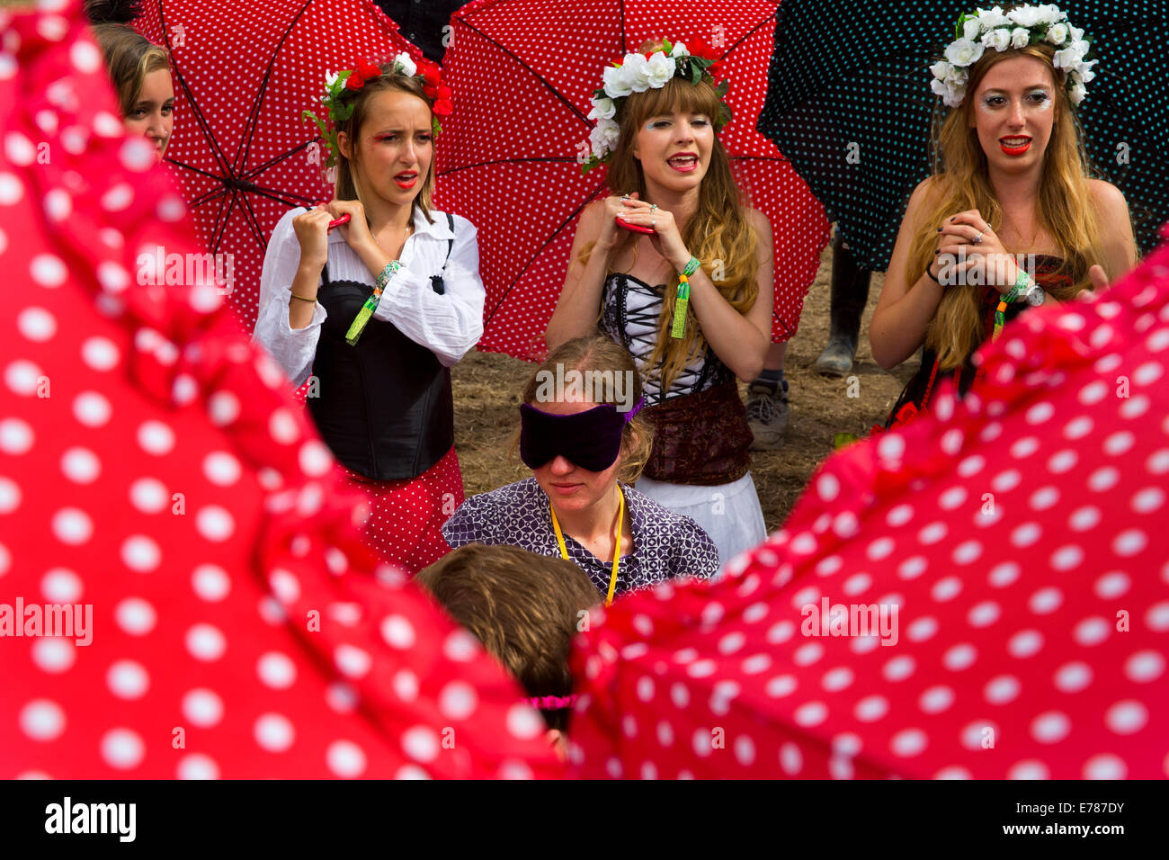 Girls singing to blindfolded friend Glastonbury Festival 2014. Stock Photo