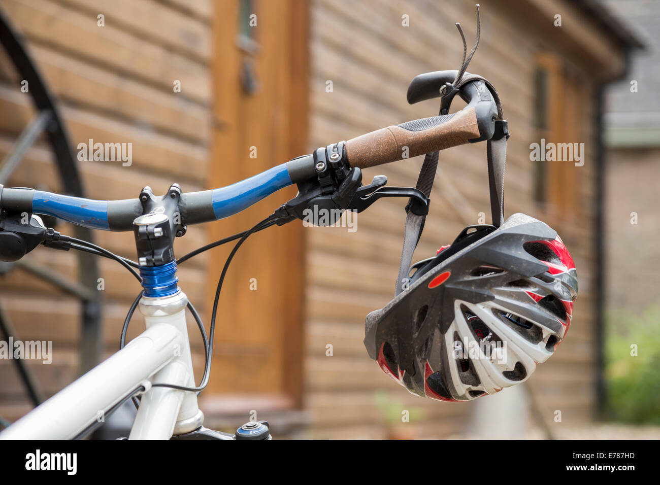 Bicycle helmet hanging from handle bars. Stock Photo