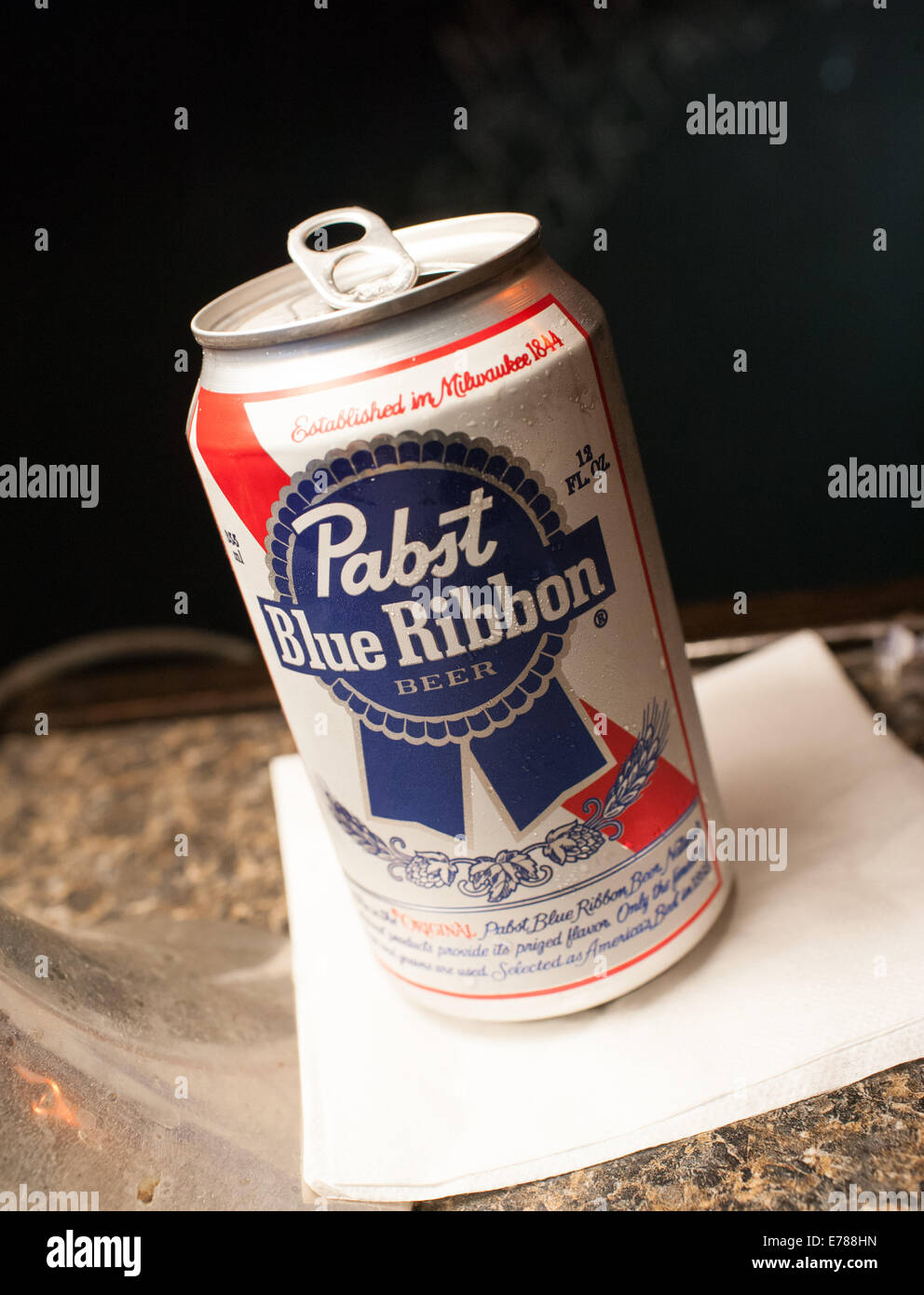 A Pabst Blue Ribbon beer sitting on a napkin on a bar Stock Photo