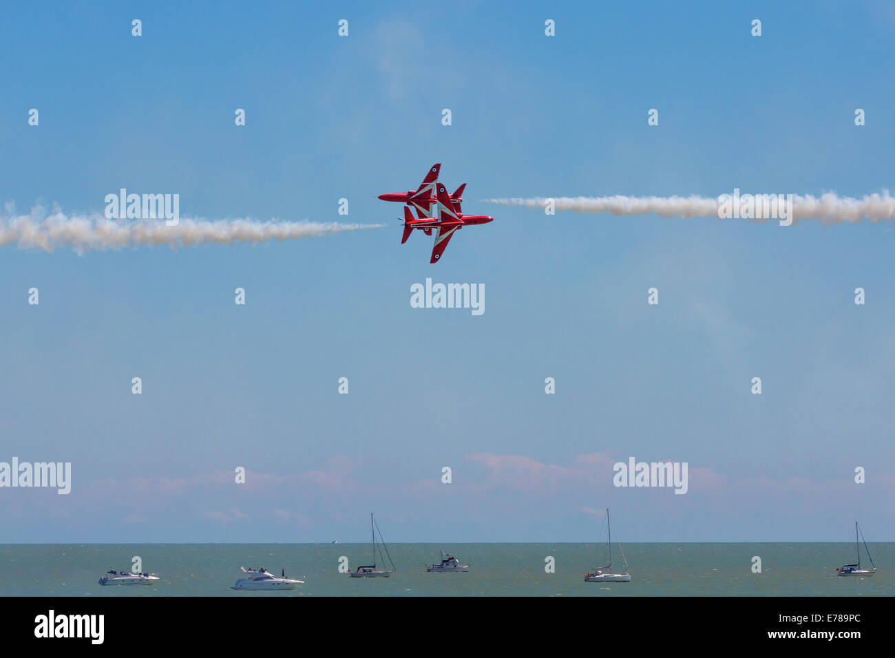 Two Red Arrows aircraft passing in a Airshow Eastbourne 2014. Stock Photo
