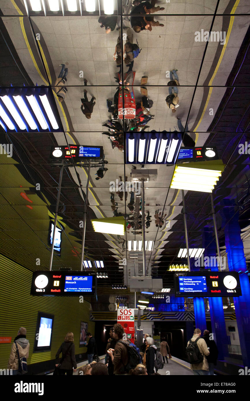 Munich, Germany: ceiling mirror reflects passengers waiting for their connections at subway station of Muenchner Freiheit, Stock Photo