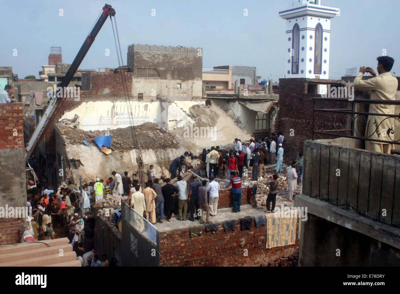 Rescuing activists are maintaining to save worshippers trapped in a roof collapses at Jama Masjid Hanafia, in Daroghawala area of Lahore on Tuesday, September 09, 2014. More than 30 worshipers trapped in roof collapses, Rescue 1122 officials with the help of locals are trying to remove debris. Six injured people have been rescued and shifted to nearby hospital. Taking notice of the incident, Punjab Chief Minister Shahbaz Sharif has directed the authorities to expedite relief efforts. Stock Photo